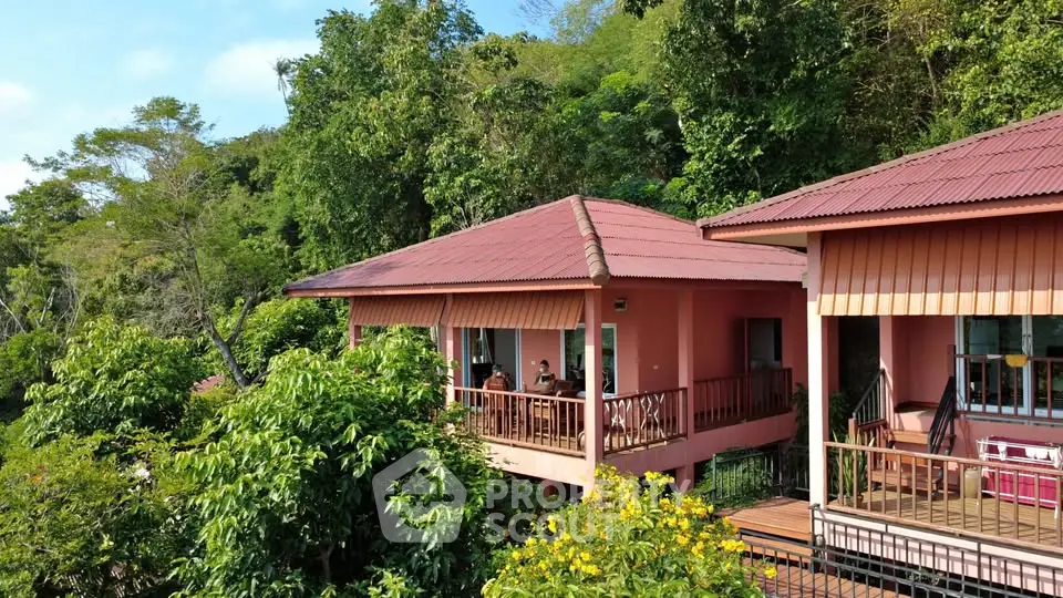 Charming pink hillside villas with lush greenery and serene surroundings.