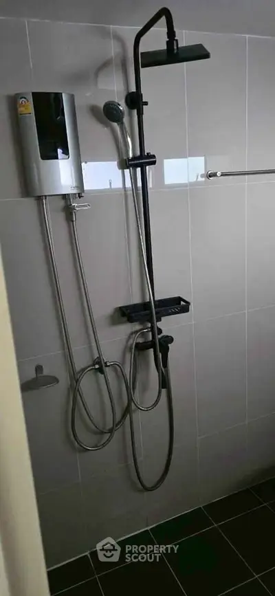Modern bathroom with sleek shower fixtures and neutral tile design.