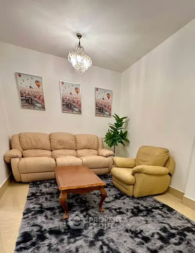 Cozy living room with plush sofa, armchair, and elegant decor