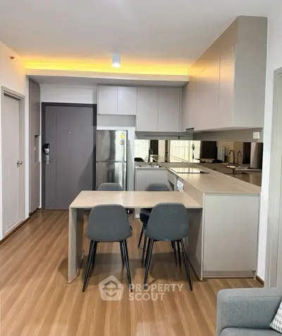 Modern kitchen with sleek design and dining area in contemporary apartment