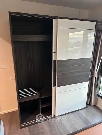 Modern wardrobe in stylish bedroom with city view