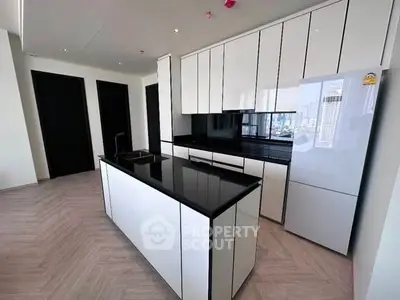 Modern kitchen with sleek black and white cabinetry and island