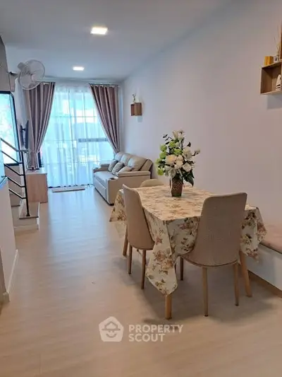 Spacious living room with elegant dining area and cozy seating, perfect for modern living.