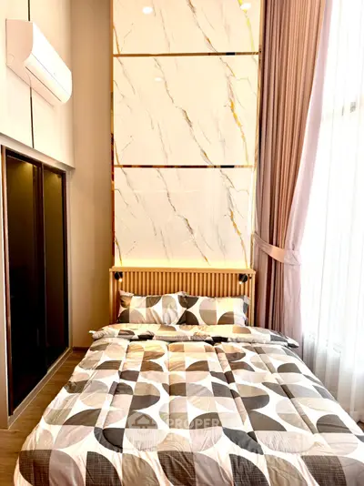 Modern bedroom with stylish decor and large window for natural light