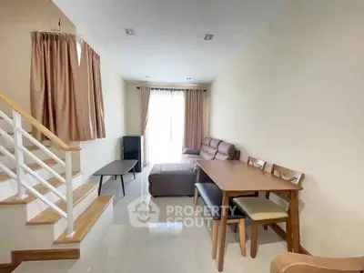 Cozy living room with modern furniture and natural light, perfect for relaxation and entertaining.