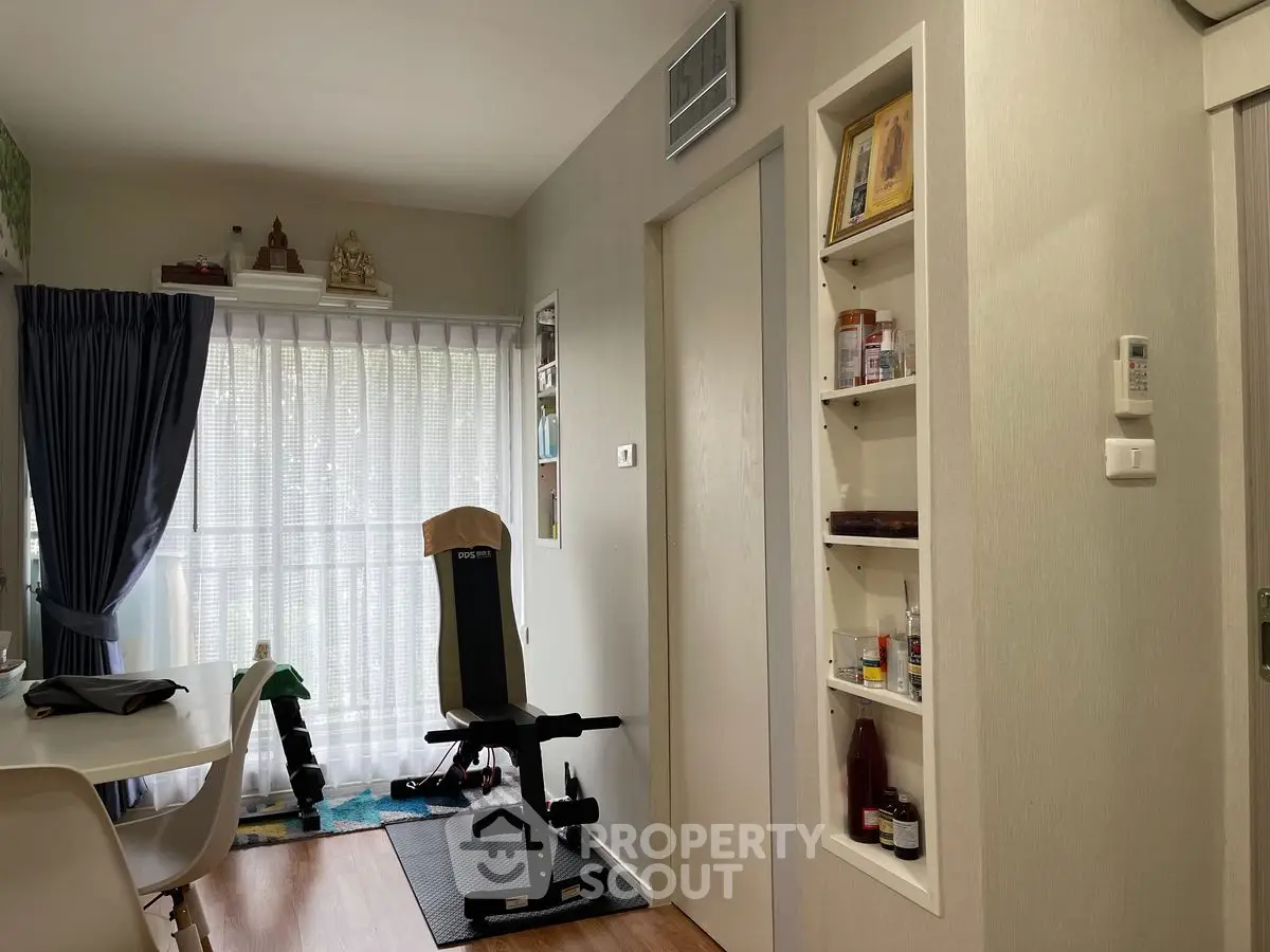 Cozy living space with exercise equipment and built-in shelving