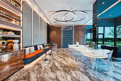Luxurious modern living room with elegant lighting and marble flooring, perfect for sophisticated gatherings.