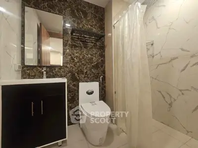 Modern bathroom with elegant marble walls and sleek fixtures