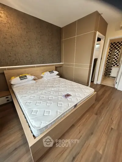 Modern bedroom with stylish decor and wooden flooring