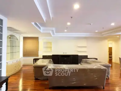 Spacious living room with modern ceiling design and hardwood floors