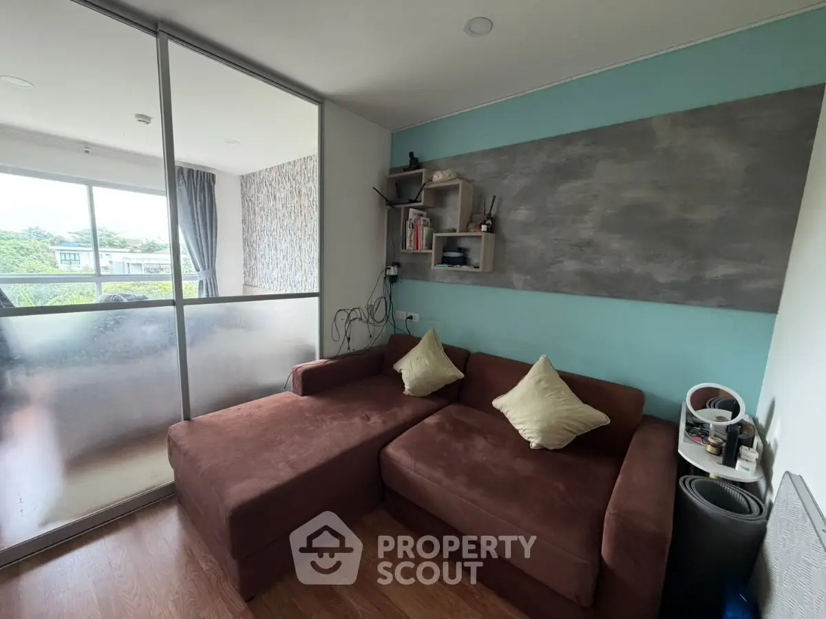 Cozy living room with brown sectional sofa and balcony view