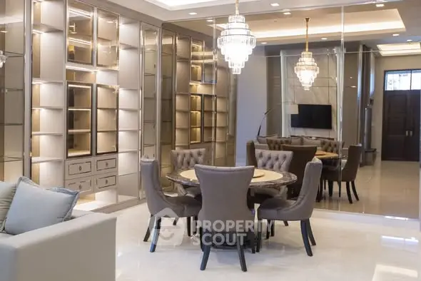 Luxurious dining area with elegant chandeliers and mirrored wall