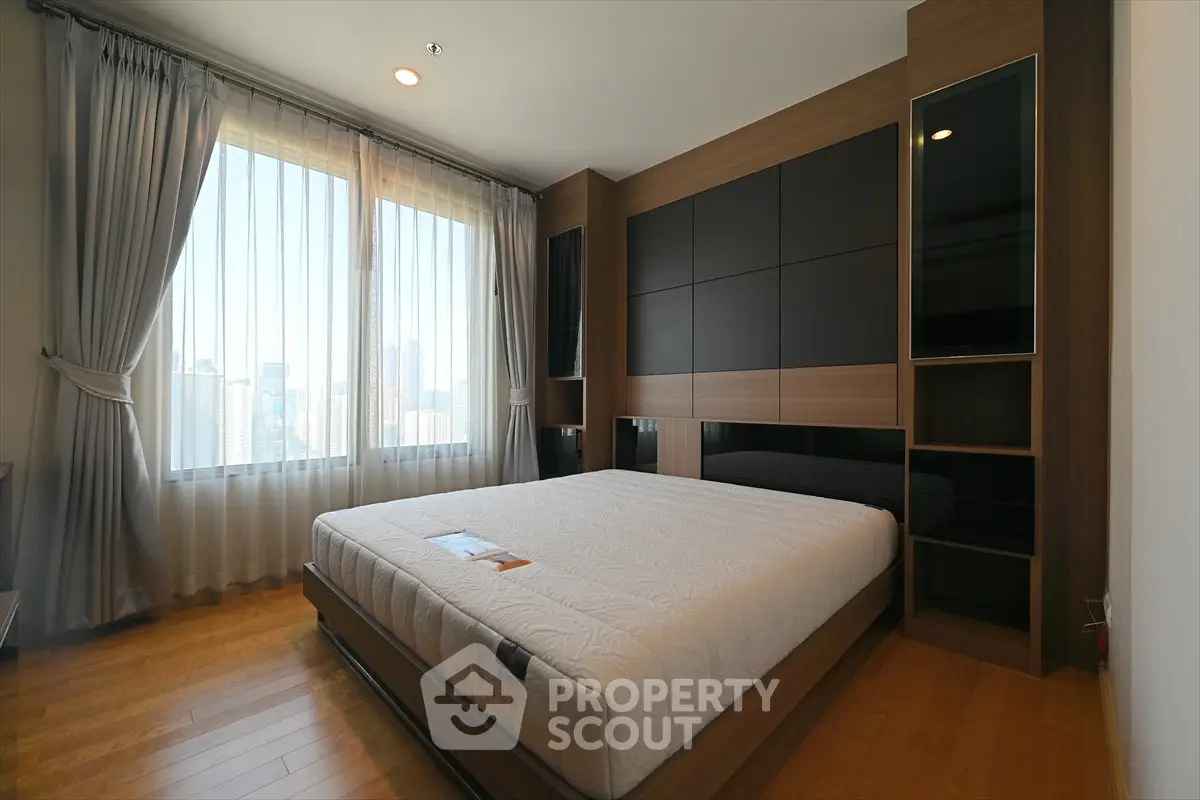 Spacious modern bedroom with large windows and elegant wood paneling