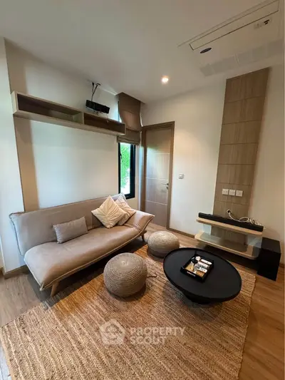 Modern living room with stylish furniture and natural light, perfect for relaxation and entertainment.