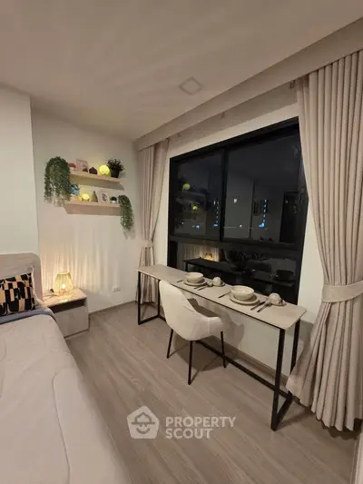 Modern living room with elegant dining setup and large window view