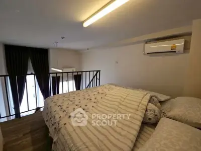 Cozy loft bedroom with modern air conditioning and elegant lighting