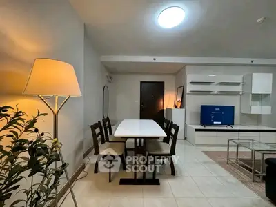 Modern living room with dining area, stylish furniture, and ambient lighting.