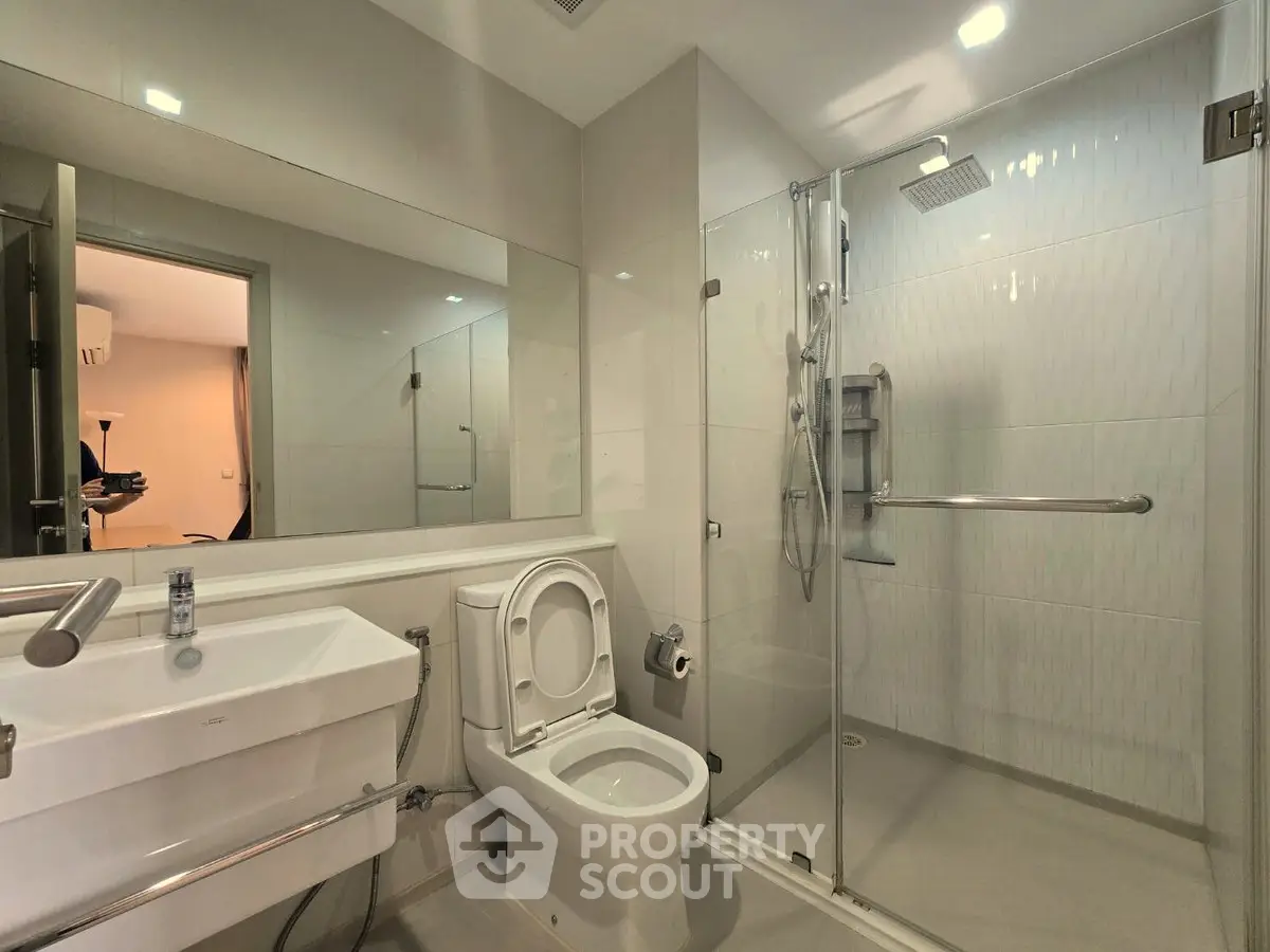 Modern bathroom with glass shower and sleek fixtures