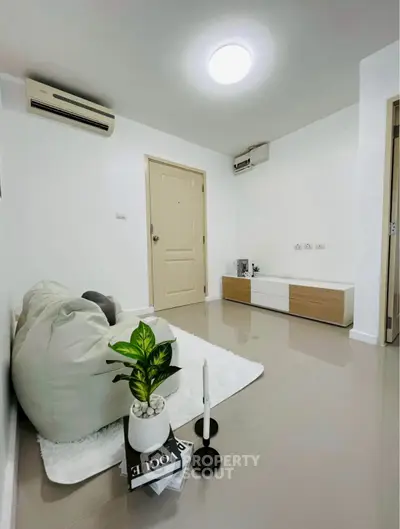 Modern minimalist living room with sleek decor and air conditioning