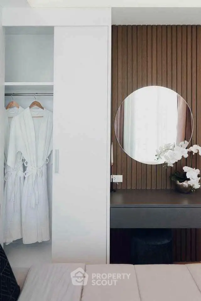 Elegant bedroom with modern closet and stylish vanity area