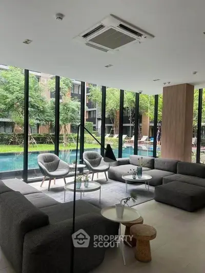 Luxurious modern living room with pool view and stylish furniture in a high-end residential complex.