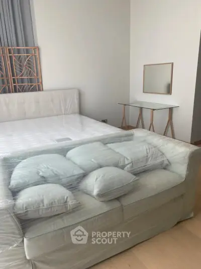 Modern bedroom with wrapped furniture and stylish decor