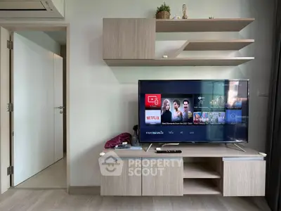 Modern living room with sleek TV setup and stylish wooden cabinetry, perfect for entertainment enthusiasts.