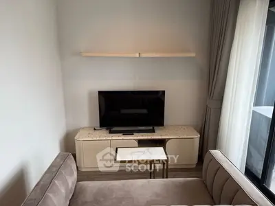 Modern living room with sleek TV setup and elegant sofa