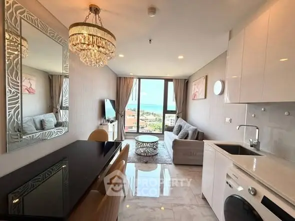 Luxurious open-plan living room with stunning sea view and modern kitchen amenities.
