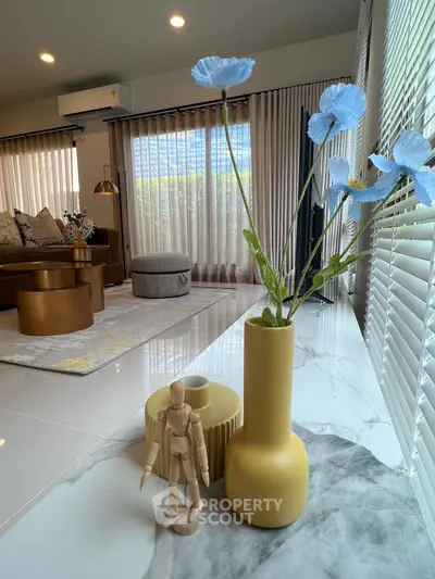 Modern living room with stylish decor and large windows for natural light.