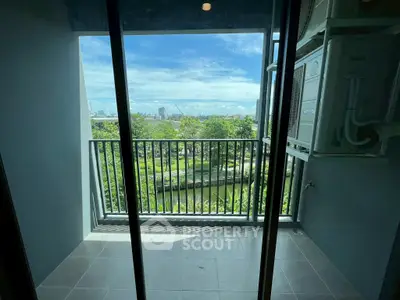 Charming balcony with serene park view, perfect for relaxation and enjoying nature's beauty.