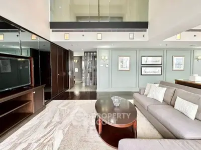 Luxurious living room with modern decor and spacious layout in upscale apartment.
