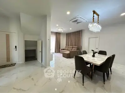Spacious modern living and dining area with elegant marble flooring and stylish lighting fixtures.