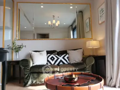 Chic living room with elegant decor, plush sofa, and stylish mirror enhancing space and light.
