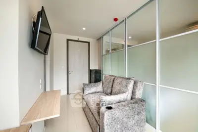 Modern living room with sleek design and wall-mounted TV in a stylish apartment.