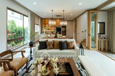 Luxurious living room with elegant decor and open layout, featuring large windows and stylish furnishings.
