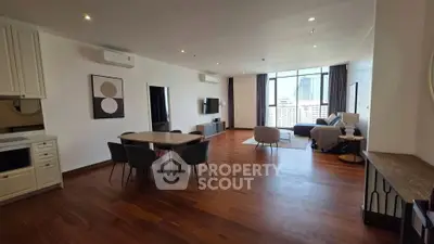 Spacious modern living room with wooden flooring and city view
