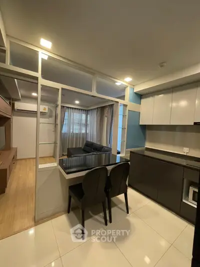 Modern open-layout kitchen with sleek cabinetry and cozy dining area