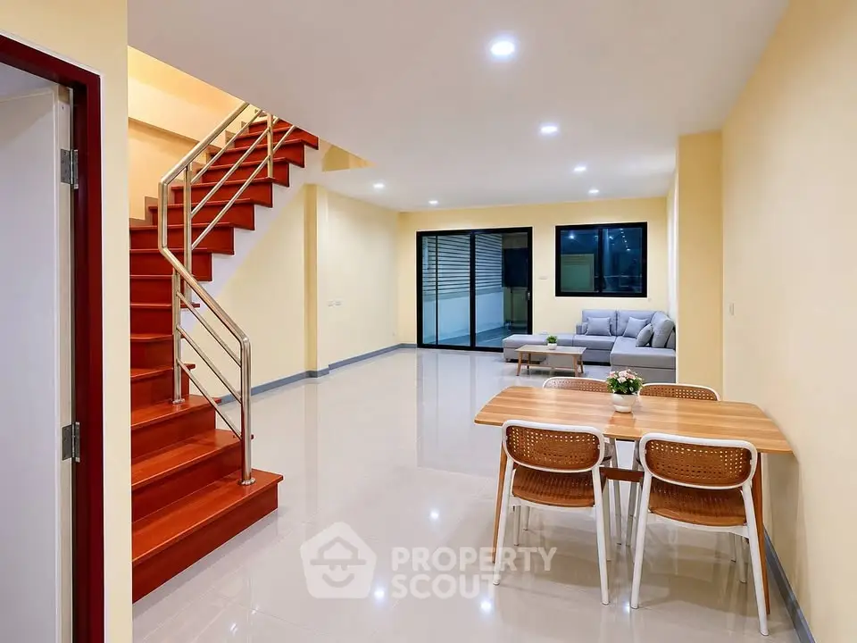 Spacious modern living room with open layout and stylish staircase