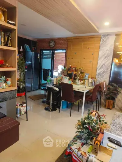 Modern living room with open layout and stylish decor, featuring a dining area and contemporary furnishings.