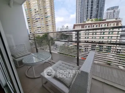 Chic urban balcony with modern seating and stunning cityscape views, perfect for relaxation and entertainment.