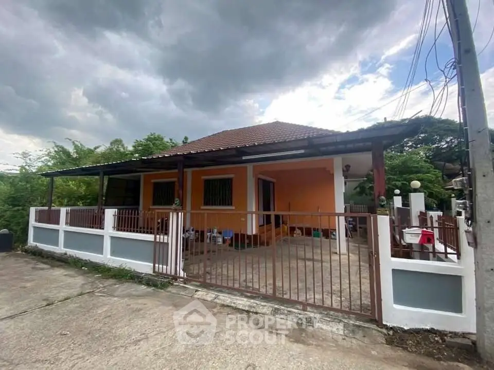 Charming single-story home with spacious front porch and fenced yard, perfect for family living.