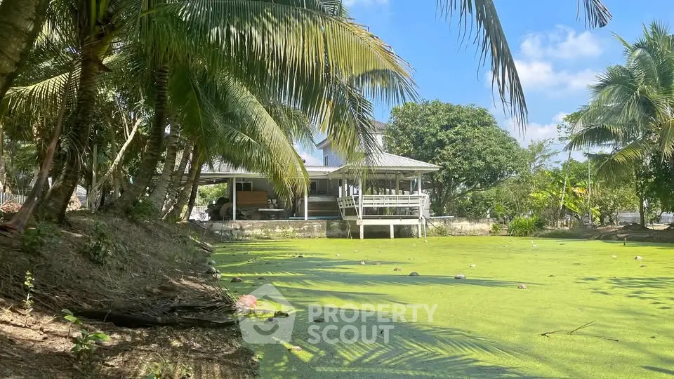 Tropical property with lush greenery and serene pond view