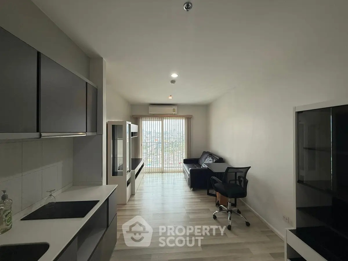 Modern living room with sleek kitchen and large window view
