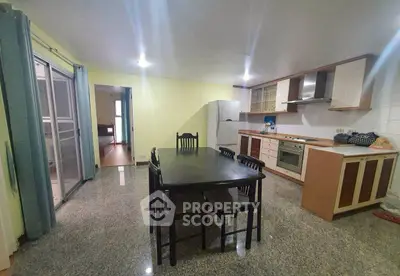 Spacious kitchen with dining area and modern appliances in open layout.