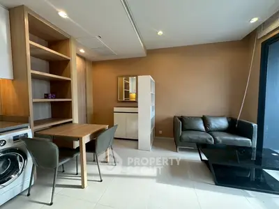 Modern living room with sleek furniture and built-in shelves in a cozy apartment.
