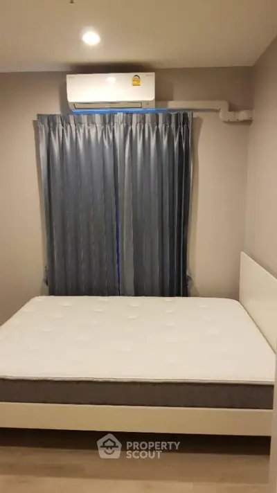 Cozy bedroom with modern air conditioning and stylish curtains