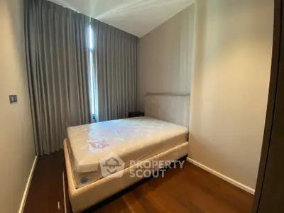 Cozy bedroom with elegant curtains and plush bed in modern apartment