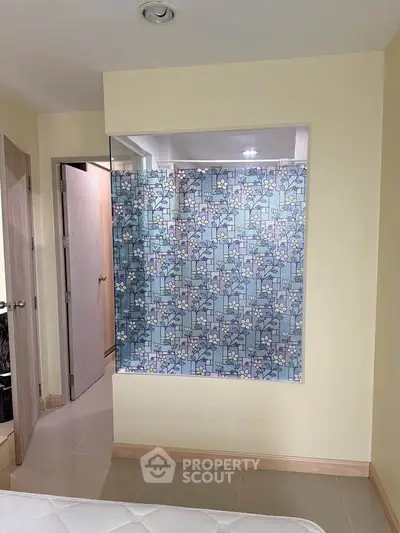 Stylish bathroom with floral glass partition and modern design