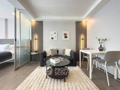 Modern living room with stylish decor and cozy ambiance, featuring a sleek sofa and elegant dining area.